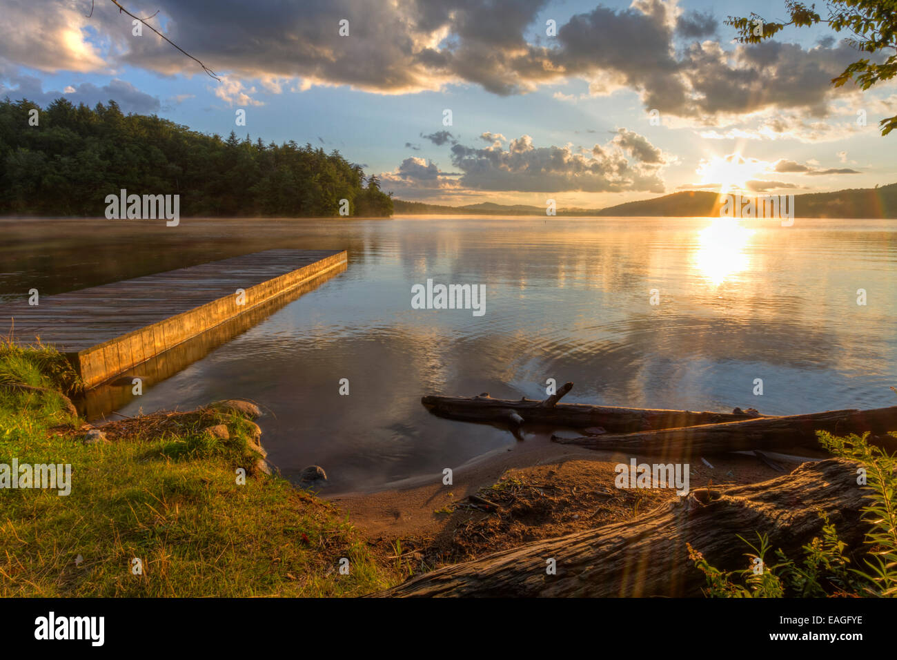 Sunset on the shore of Seventh Lake in the Fulton Chain Lakes region of the Adirondack Mountains of New York Stock Photo