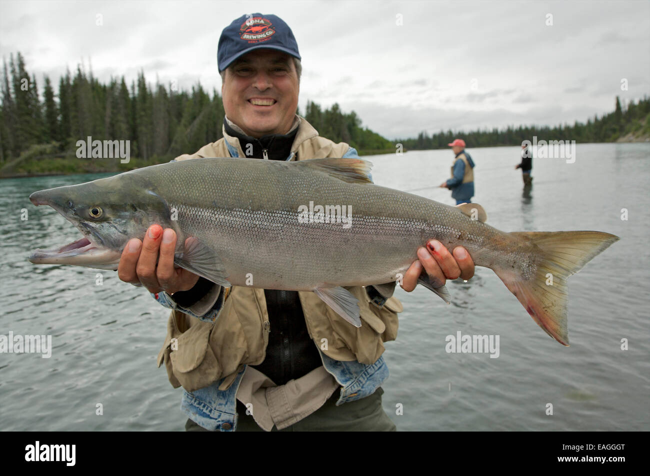 Angler Poses While Holding His Caught Salmon On The Kenai River, Kenai