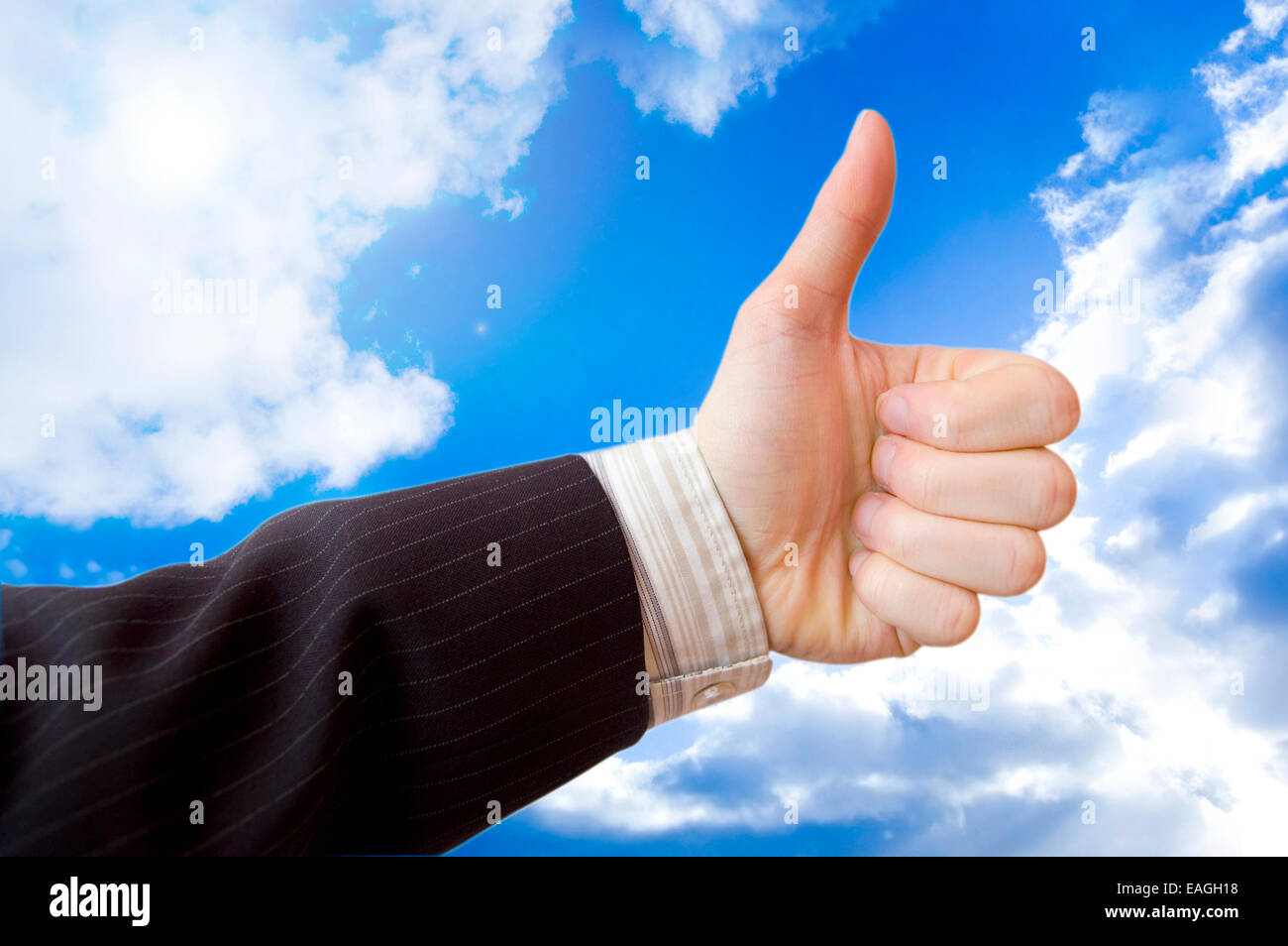 Success in business conceptual image. Businessman hand against the blue sky. Stock Photo
