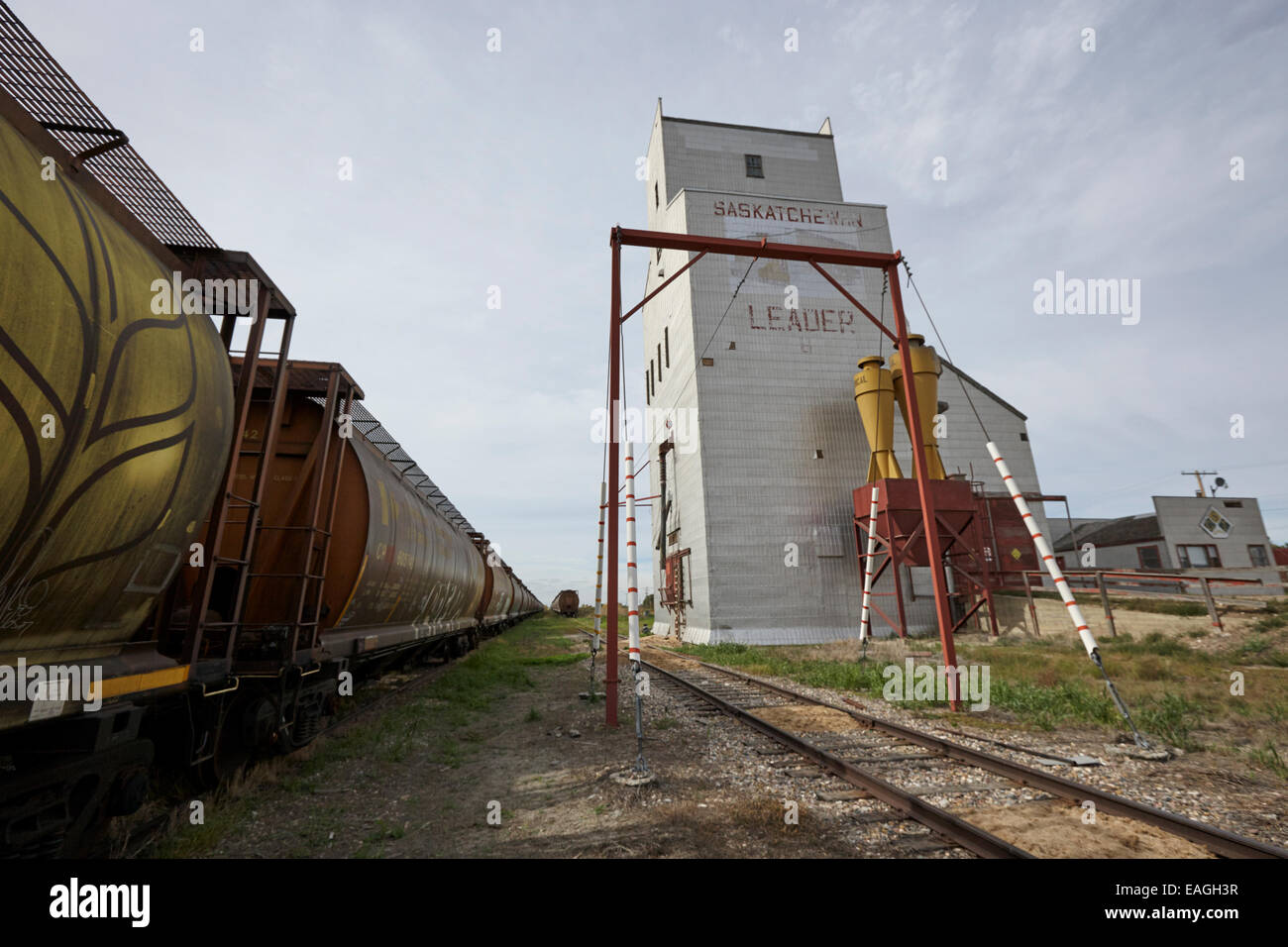 grain elevator and old train track with grain railcars leader Saskatchewan Canada Stock Photo