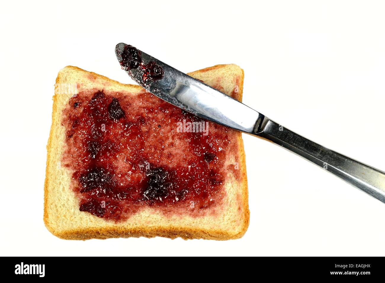 White bread with jelly and a knife on a white background Stock Photo