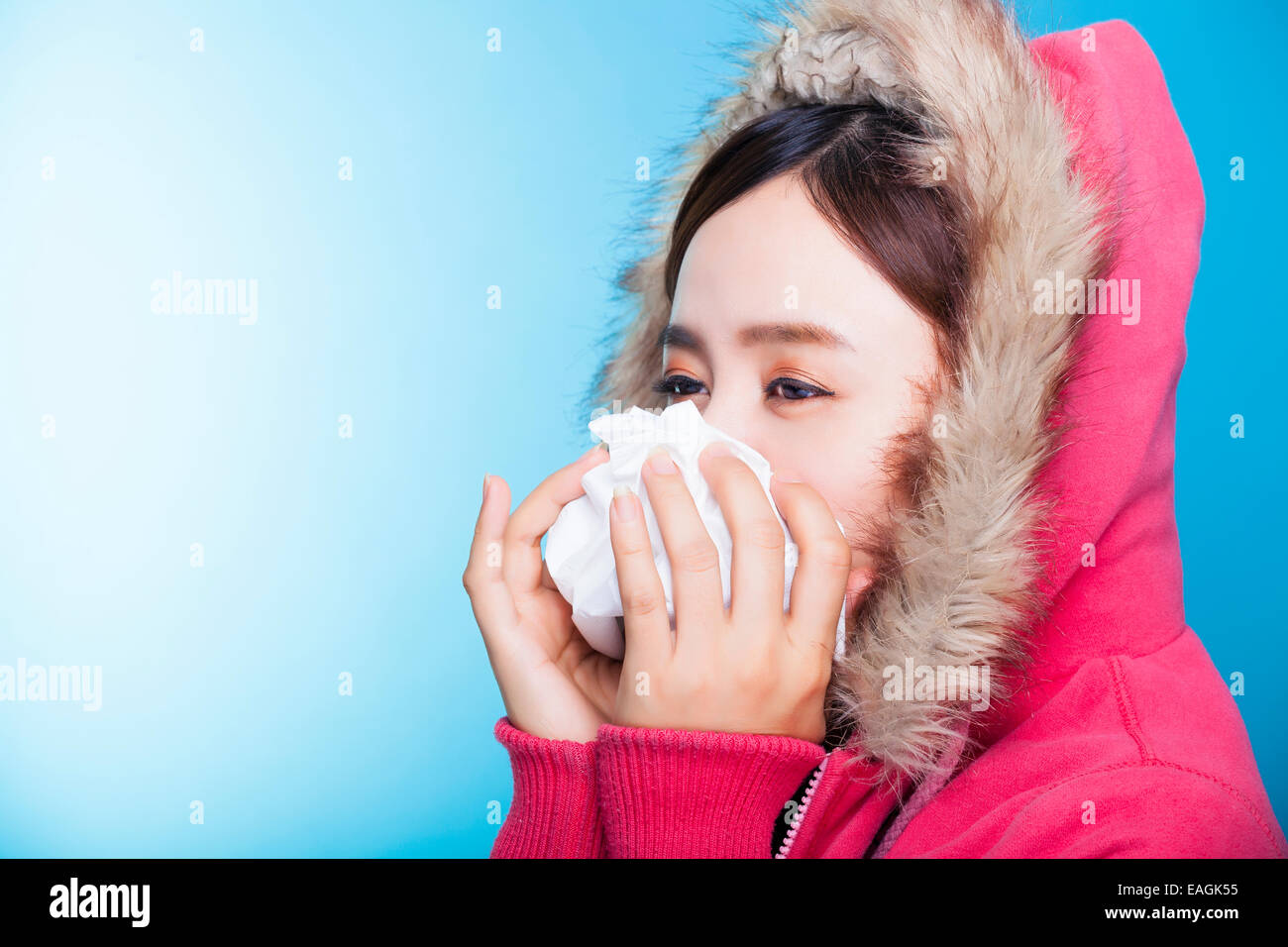 young Woman blowing her nose Stock Photo