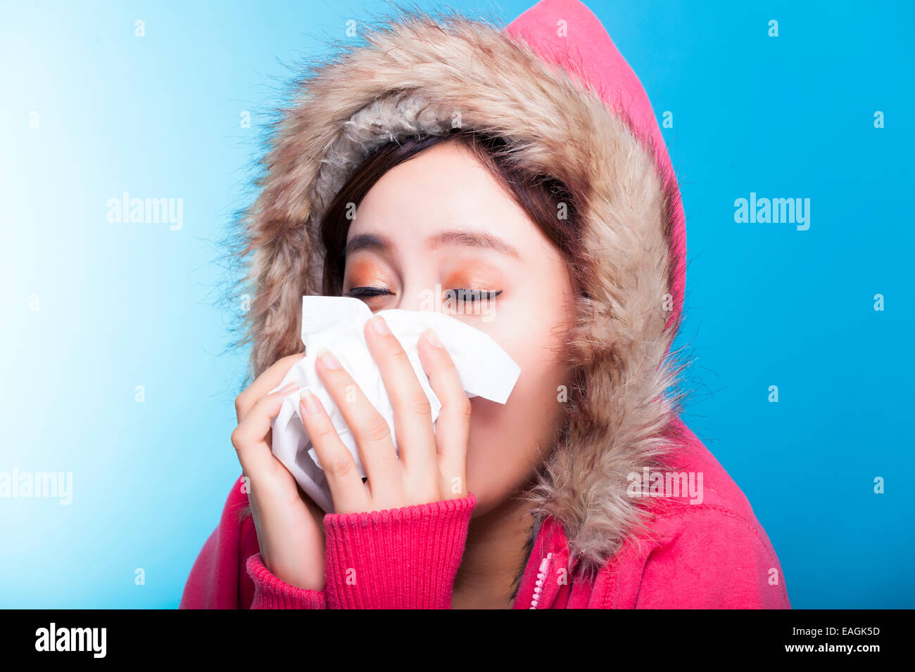 young Woman blowing her nose Stock Photo