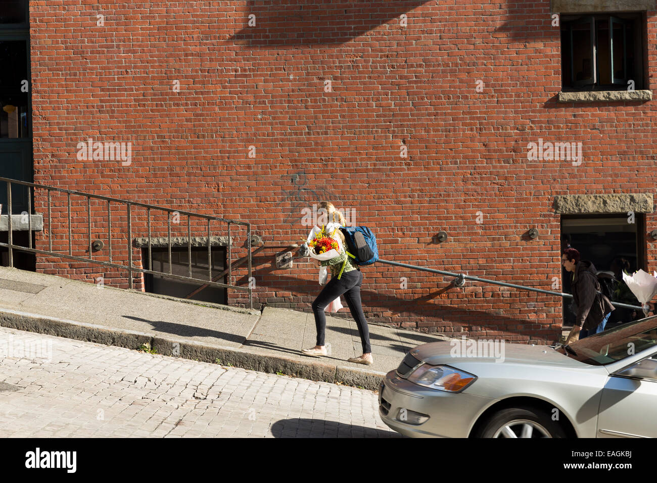 Woman walking up steep hill hi-res stock photography and images - Alamy