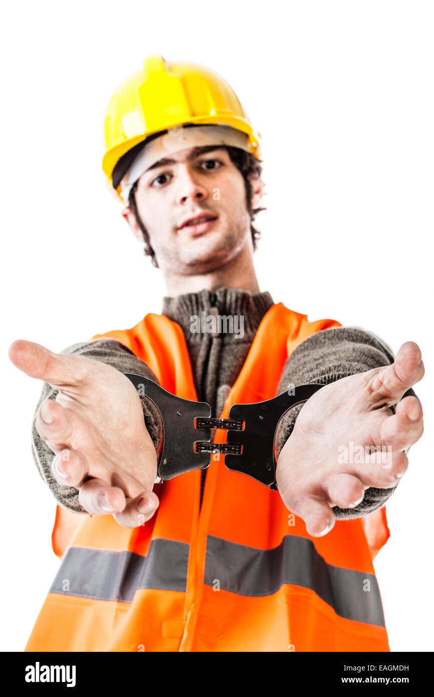 an engineer or a foreman wearing hard hat and reflective vest arrested with handcuffs isolated on white Stock Photo