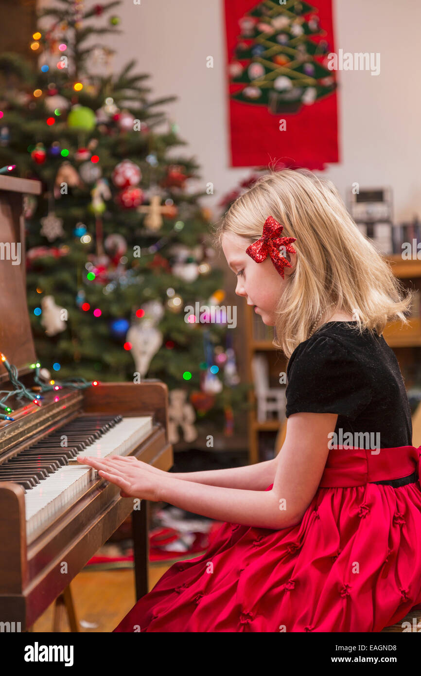 Six Year Old Girl Wearing A Formal Dress Red Bow In Her Hair Playing