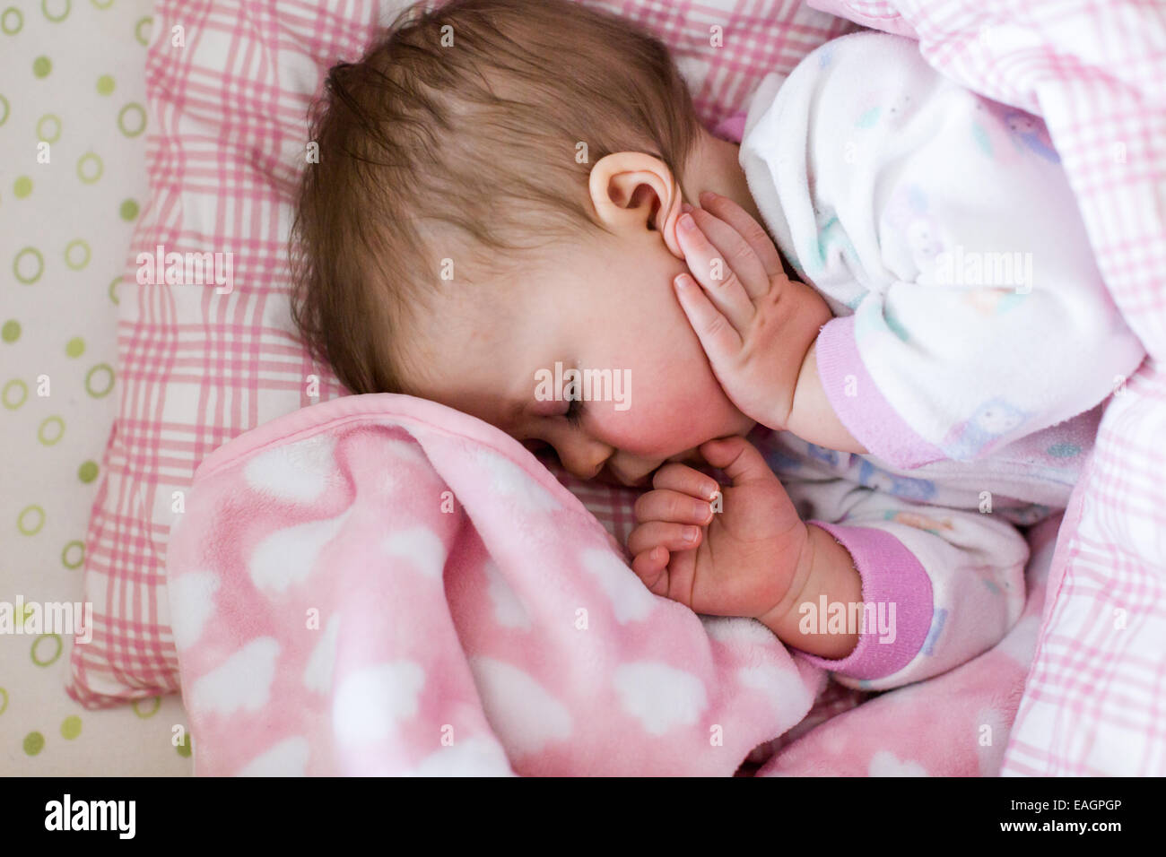 Cute baby girl sleeping in her crib Stock Photo Alamy