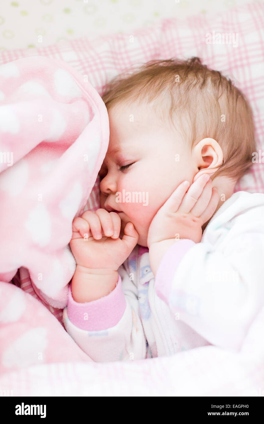 Cute baby girl sleeping in her crib Stock Photo Alamy