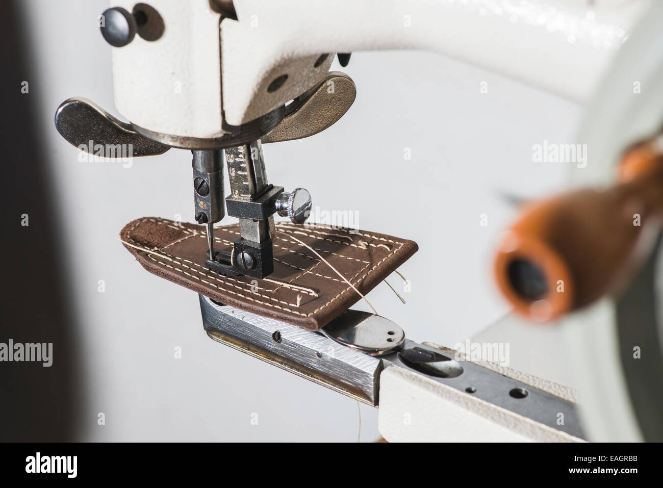 Sewing leather. Manual machine Stock Photo