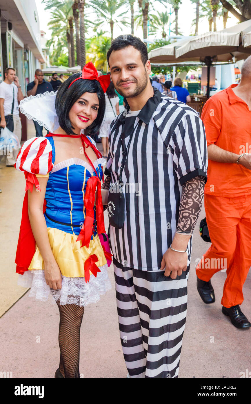 Miami Beach Florida,Lincoln Road,pedestrian mall arcade,Halloween,costume,wearing,outfit,character,Snow White,prisoner,stripes,adult adults man men ma Stock Photo