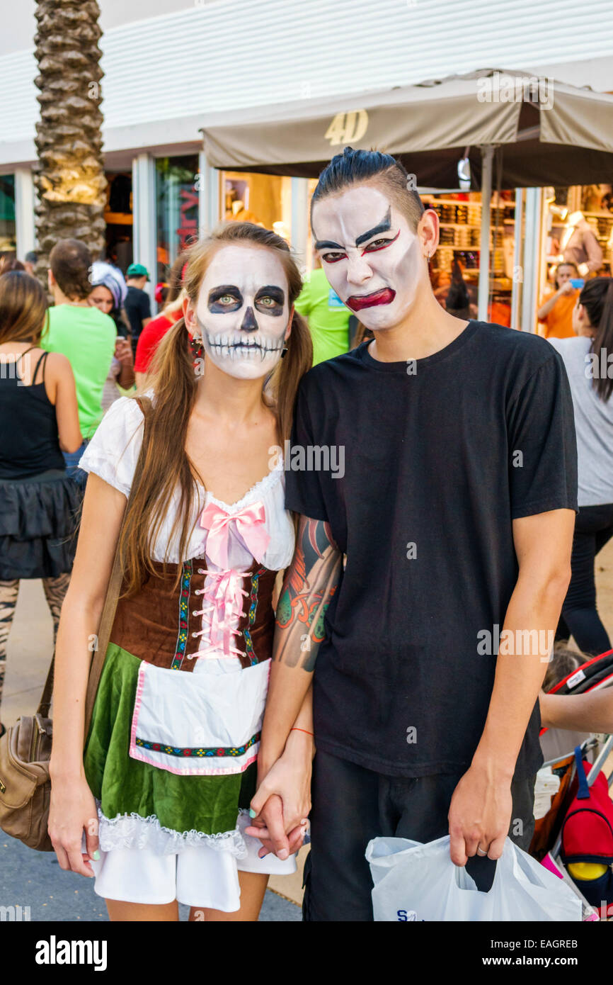 Miami Beach Florida,Lincoln Road,pedestrian mall arcade,Halloween,costume,wearing,outfit,character,face painting,skull,Asian Asians ethnic immigrant i Stock Photo
