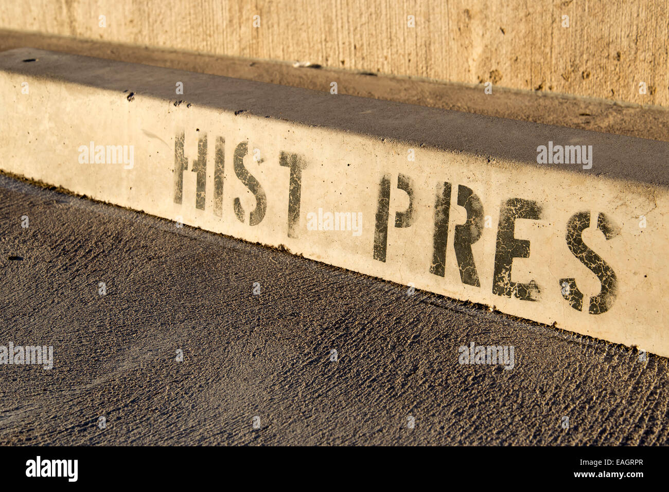 historic preservation reserved parking block with painted worn letters Stock Photo