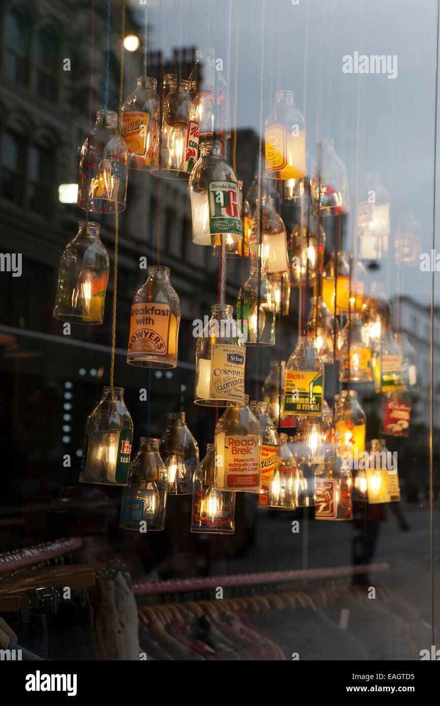 'Cow' clothing store with illuminated broken glass bottles as lamp shades creating Art Deco appearance, Manchester, UK. Stock Photo