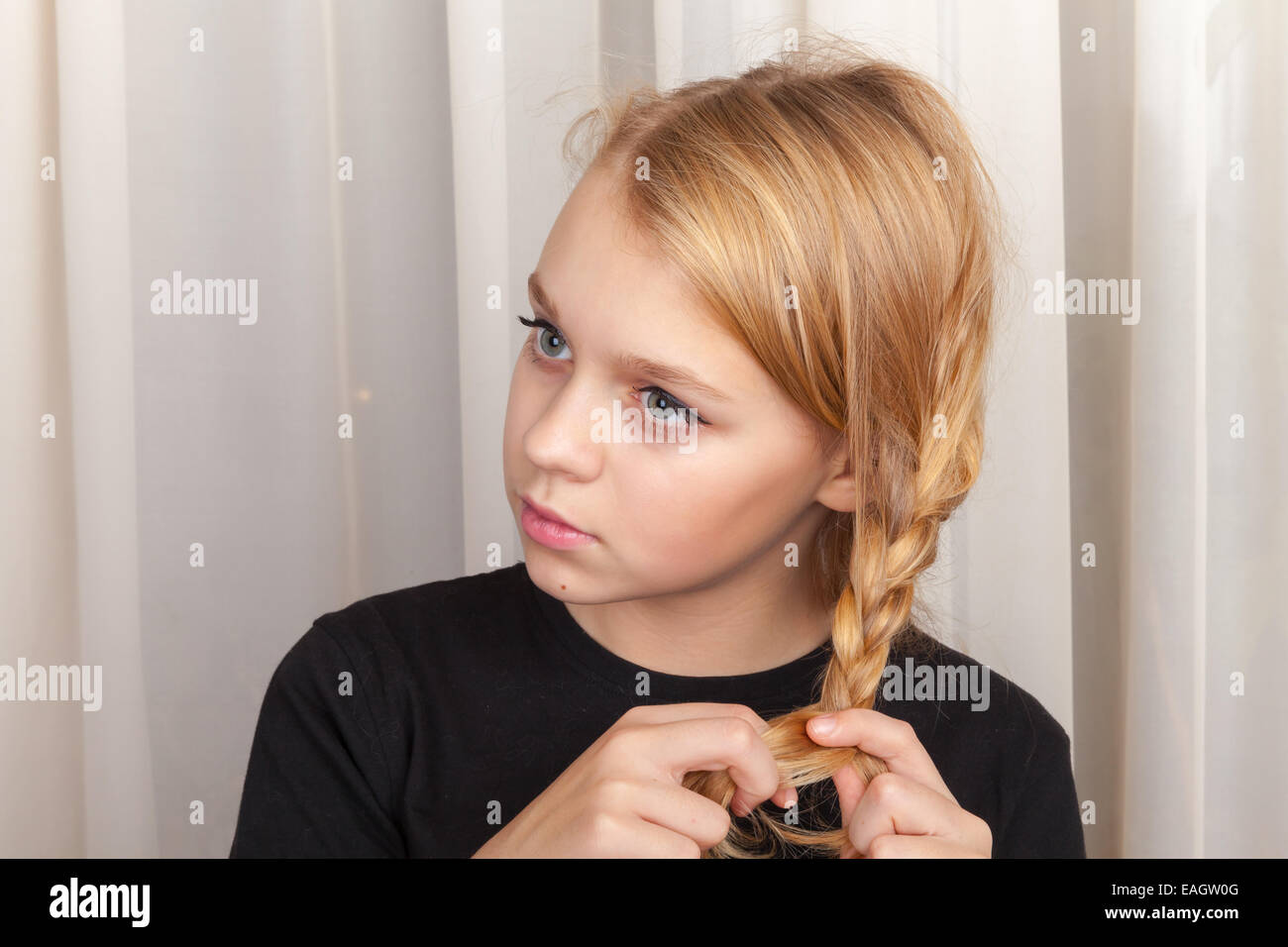 Blond Caucasian girl braids plait, closeup studio portrait Stock Photo