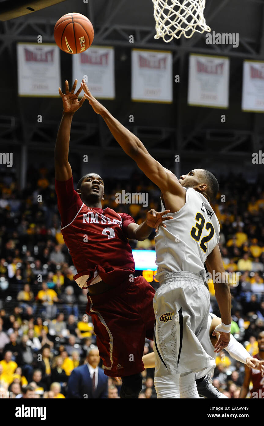 Wichita, Kansas, USA. 14th Nov, 2014. New Mexico State Aggies forward Remi Barry (3) shoots the ball over Wichita State Shockers guard Tekele Cotton (32) during the NCAA Basketball game between the New Mexico State Aggies and the Wichita State Shockers at Charles Koch Arena in Wichita, Kansas. Kendall Shaw/CSM/Alamy Live News Stock Photo