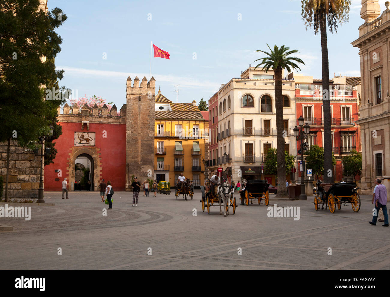 Horse and carriage rides for tourists through the historic central areas of Seville, Spain Stock Photo