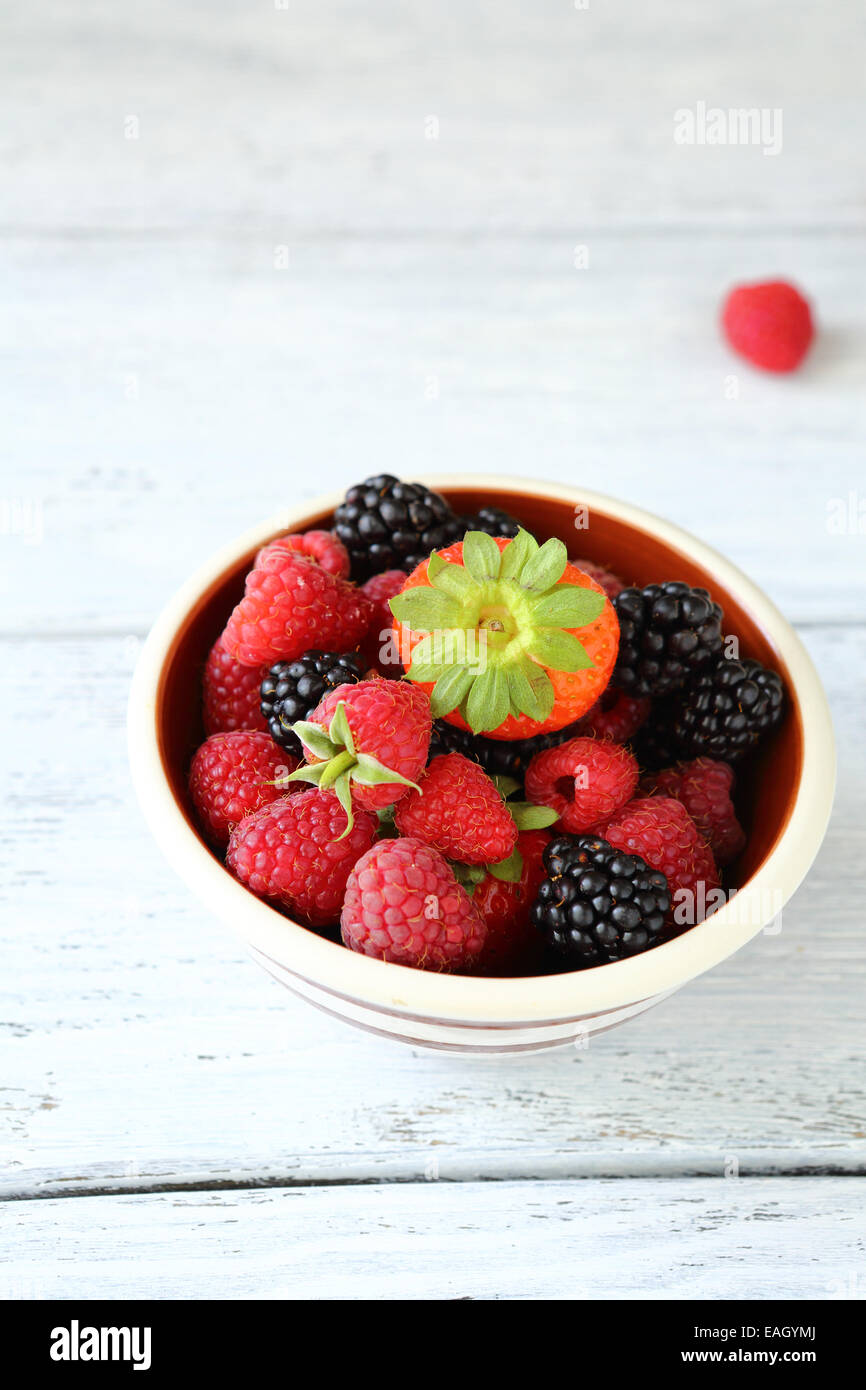 Raspberries, blueberries and strawberry in a bowl, healthy food Stock Photo