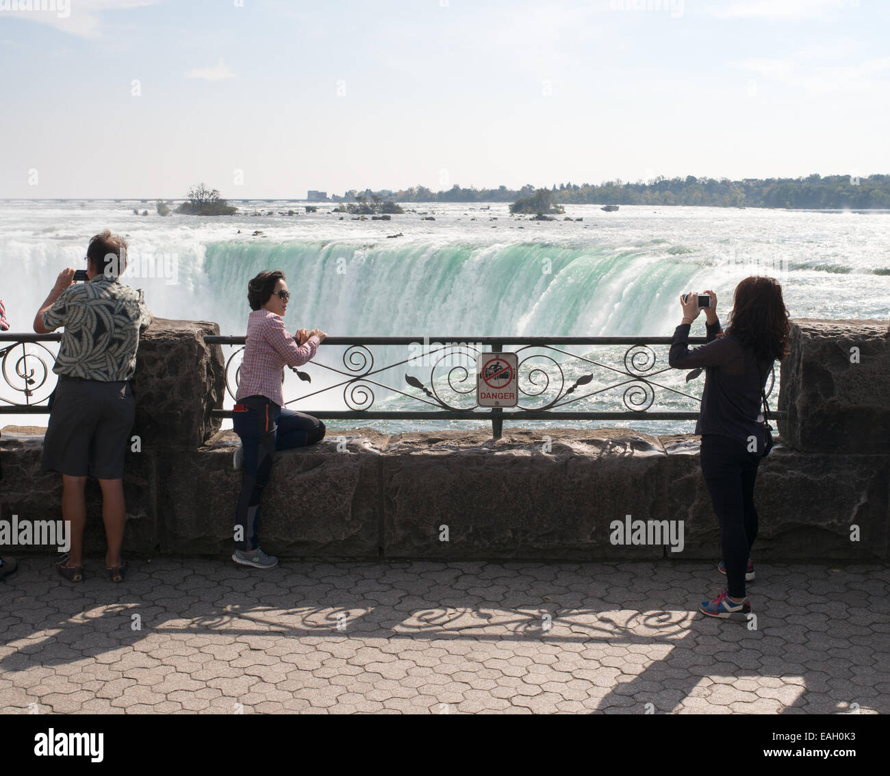 Two young Asian appearance women taking photograph at Horseshoe Falls