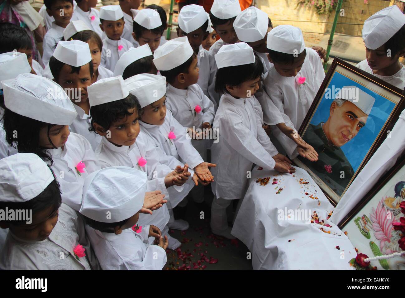 Children dressed up Chacha Nehru and pay floral tribute on the portrait of former Prime Minister Jawaharlal Nehru on the eve of his 125th birth anniversary at Allahabad. © Amar Deep/Pacific Press/Alamy Live News Stock Photo
