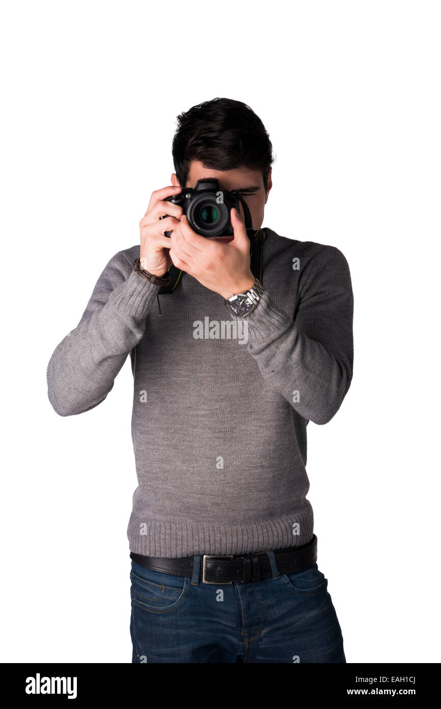 Handsome young man taking photo with professional photocamera, standing isolated on white Stock Photo