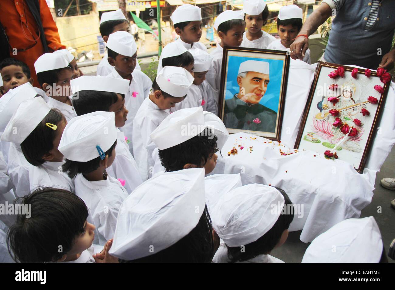 Children dressed up Chacha Nehru and pay floral tribute on the portrait of former Prime Minister Jawaharlal Nehru on the eve of his 125th birth anniversary at Allahabad. © Amar Deep/Pacific Press/Alamy Live News Stock Photo