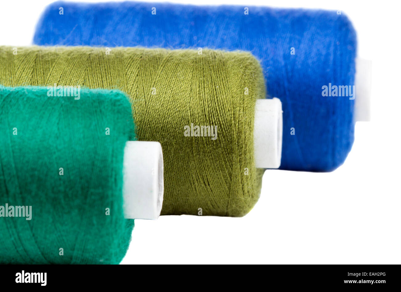 Close up of three thread spools, isolated on white background Stock Photo