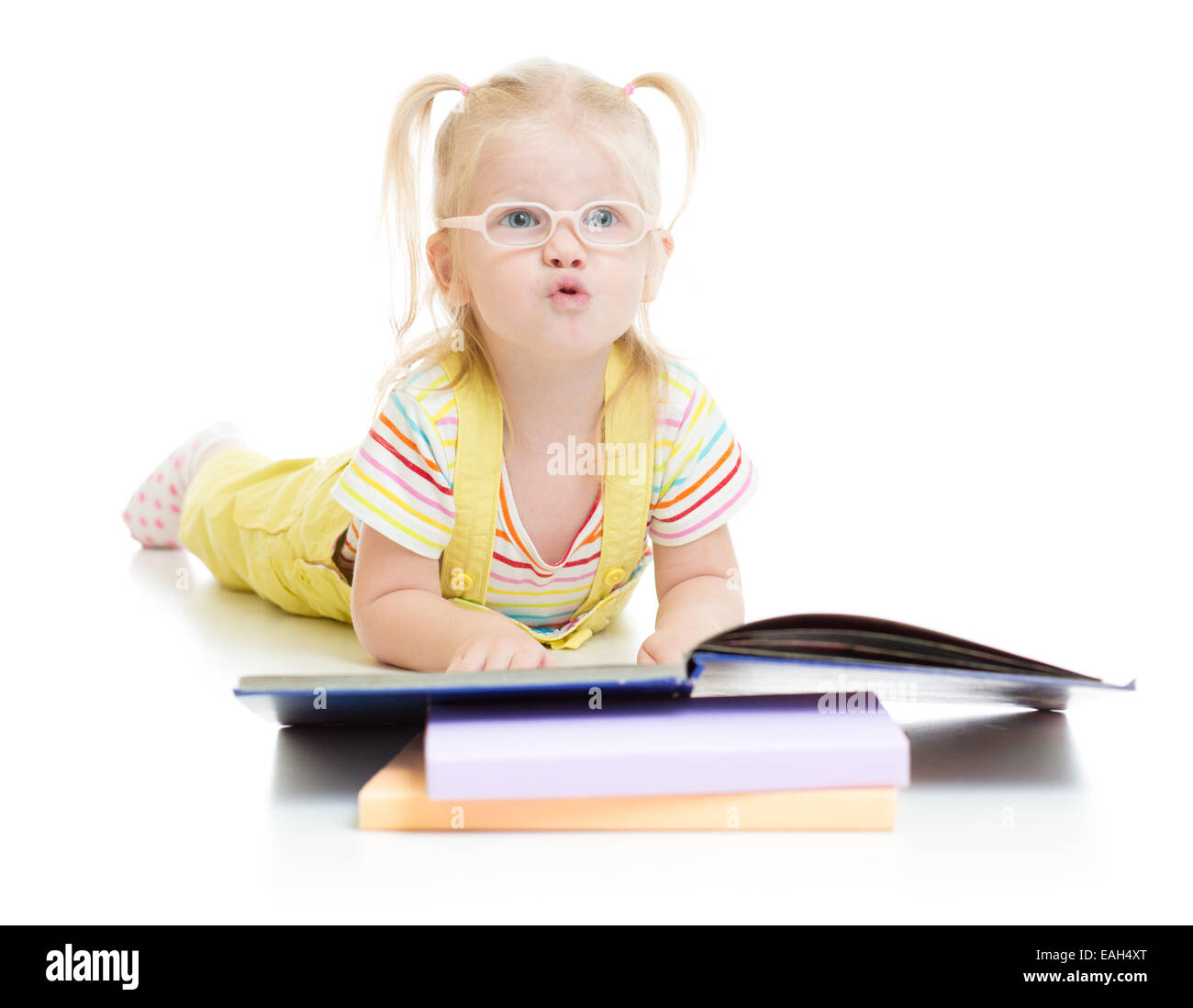 Funny kid in eyeglases reading book isolated Stock Photo
