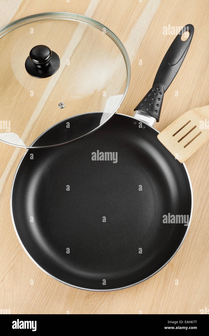 frying pan with lid on wooden table Stock Photo