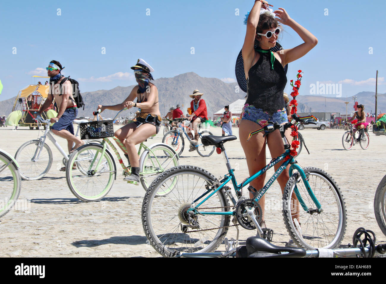 Bicyclists on the playa at the annual Burning Man festival in the desert August 26, 2014 in Black Rock City, Nevada. Stock Photo