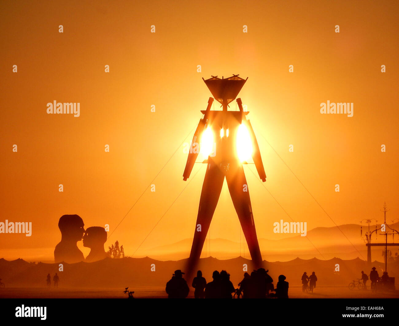 Sunset over the Burning Man statue on the playa at the annual Burning Man festival in the desert August 26, 2014 in Black Rock City, Nevada. Stock Photo