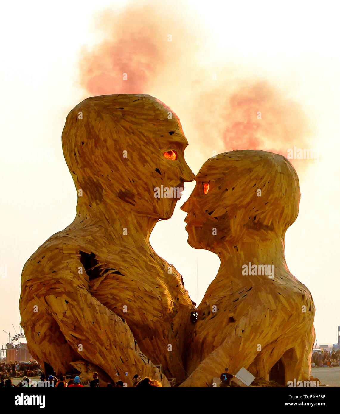 The art installation Embrace is set on fire on the playa at the annual Burning Man festival in the desert August 29, 2014 in Black Rock City, Nevada. Stock Photo