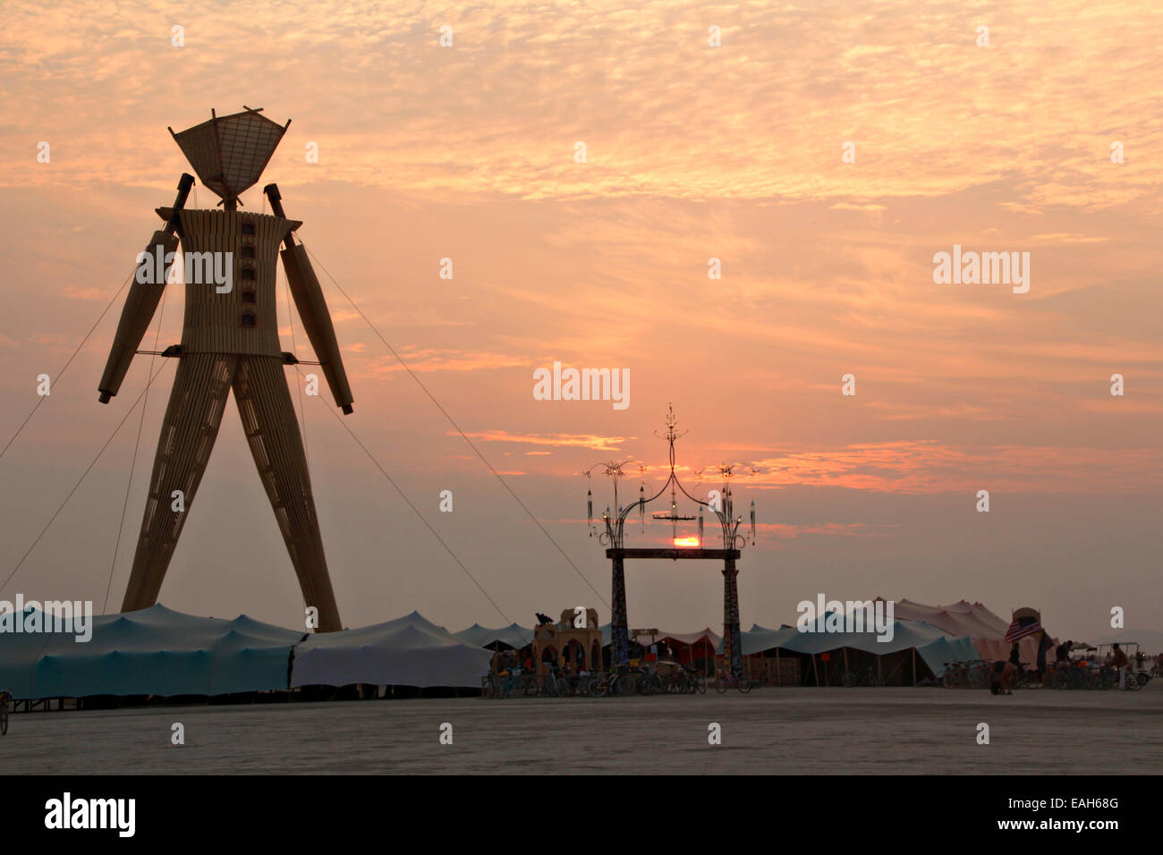 Sunrise over the art installation Burning Man on the playa at the annual Burning Man festival in the desert August 29, 2014 in Black Rock City, Nevada. Stock Photo