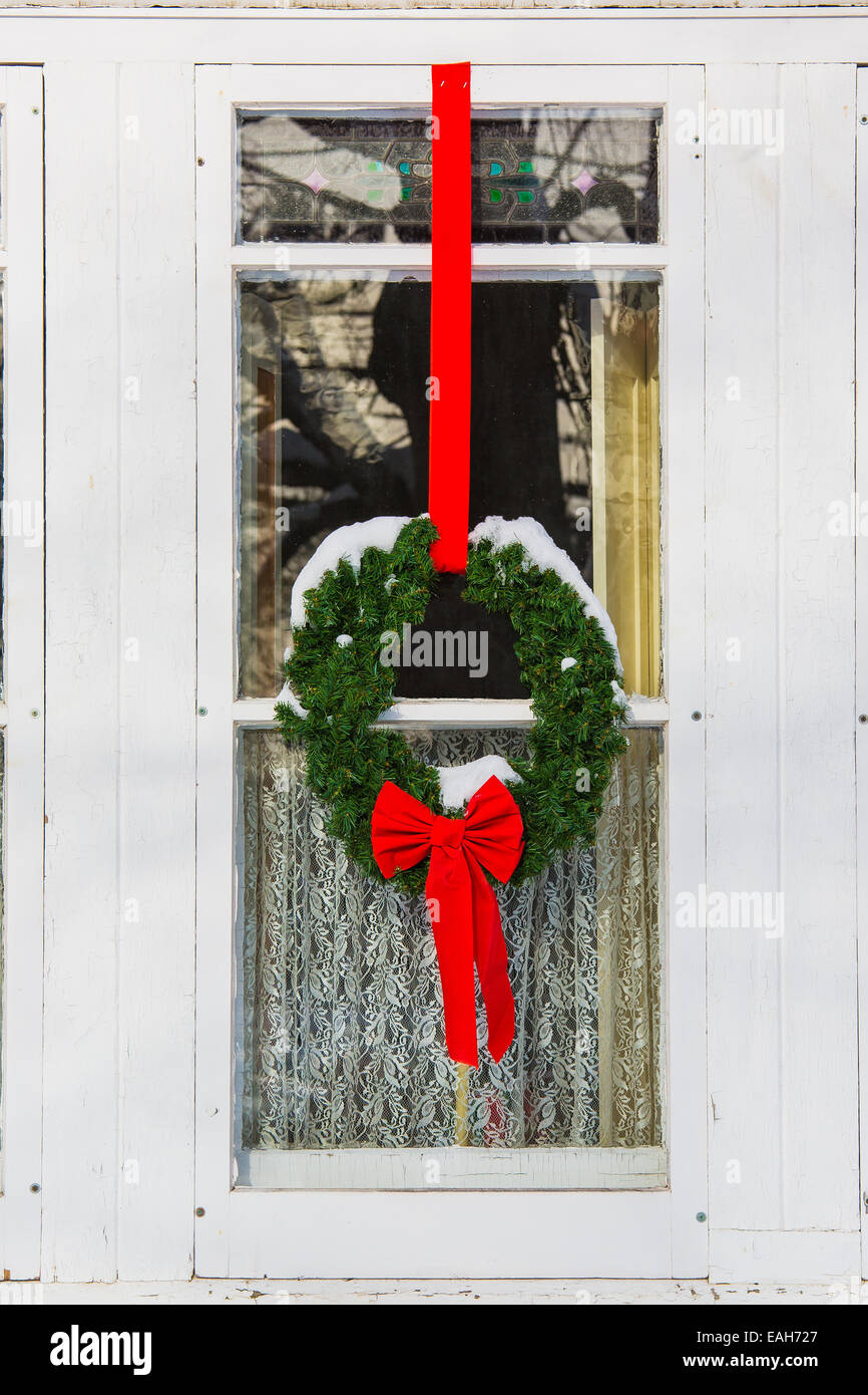Christmas wreath and garland decorating an older style home Stock Photo