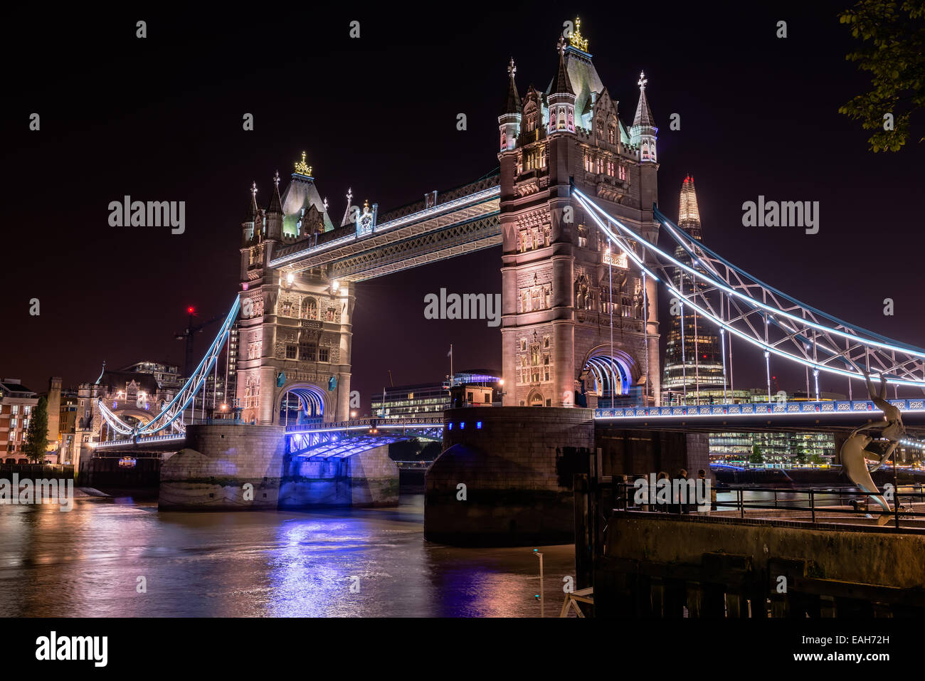 illuminated Tower Bridge at night, seen from northbank - London, UK Stock Photo