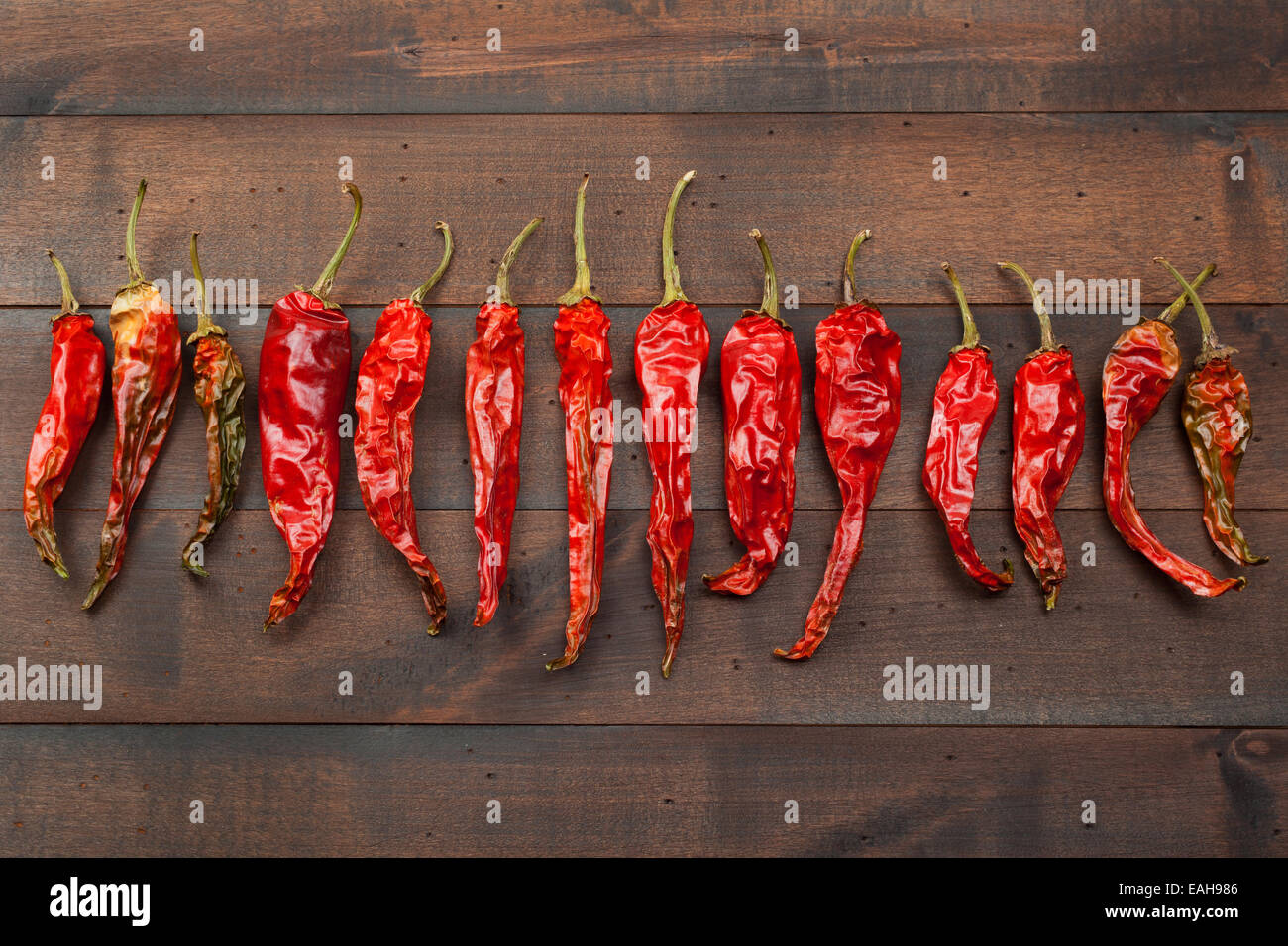 red chili peppers on wooden table Stock Photo - Alamy