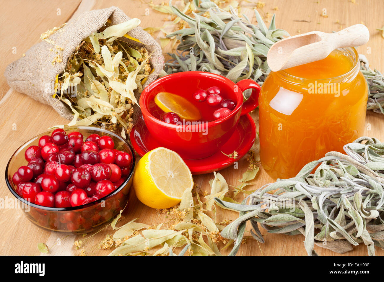 cranberries, jar with honey, fruit tea cup, healing herbs and lemon Stock Photo