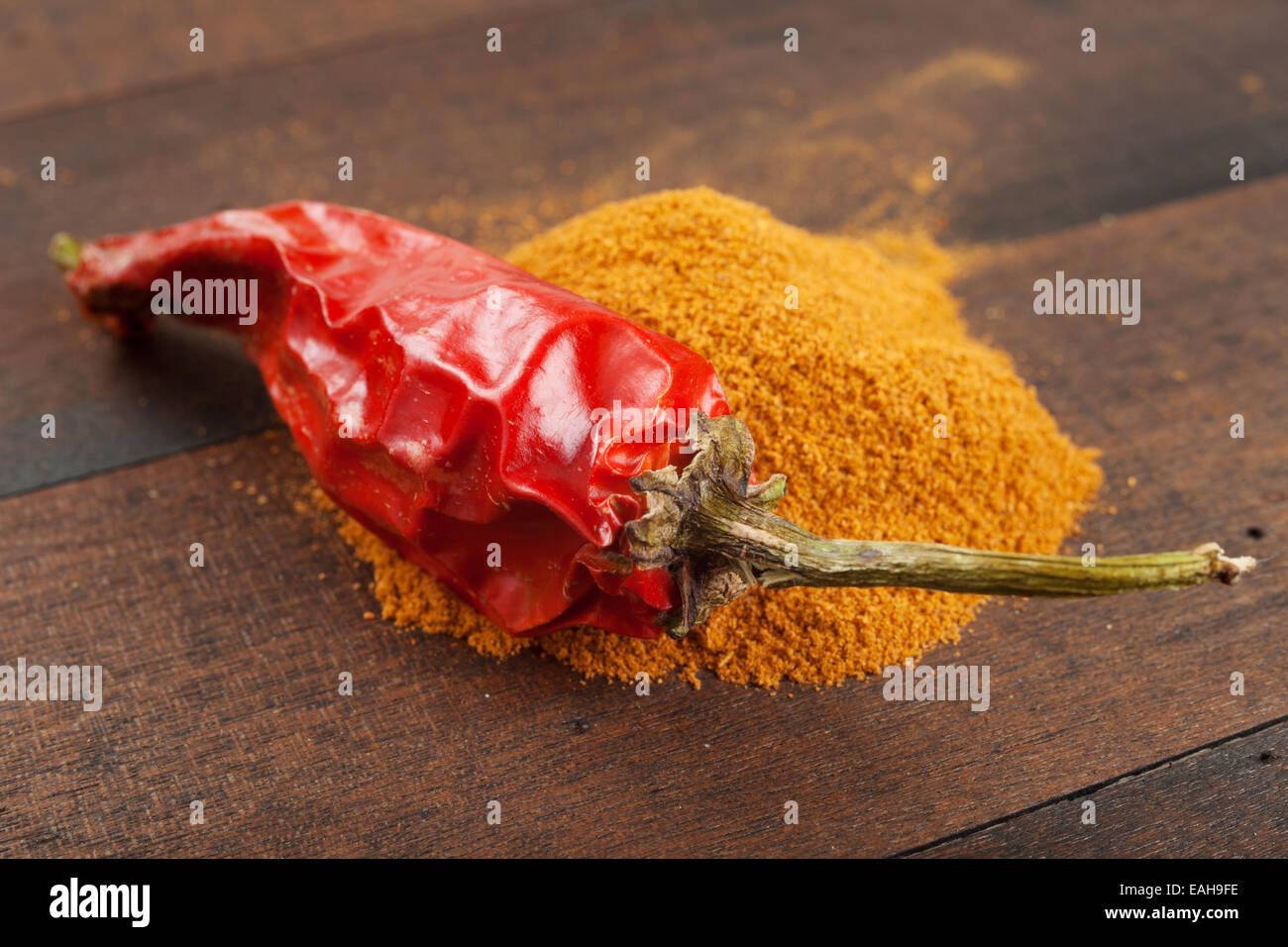 red chili pepper and pile of ground chilly Stock Photo Alamy