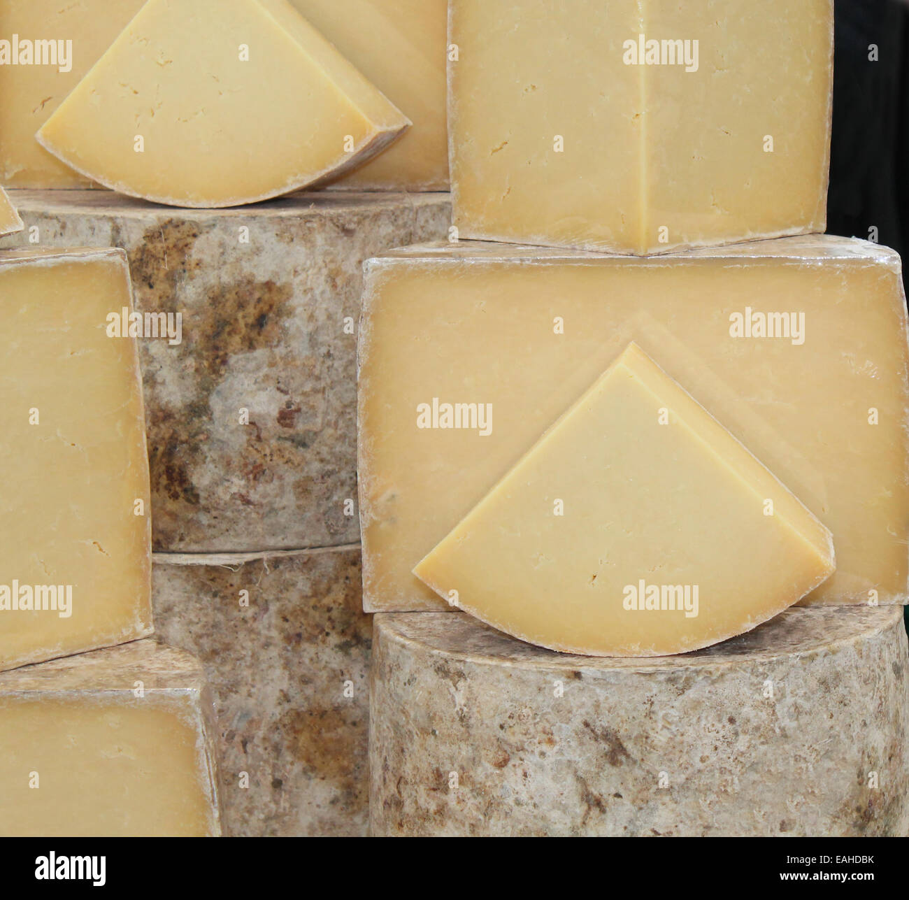 A Collection of Hard Round Cheeses on Display. Stock Photo