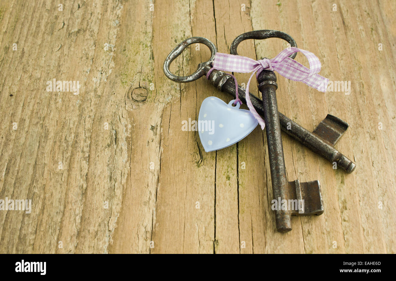 two Keys and heart on wooden ground Stock Photo - Alamy