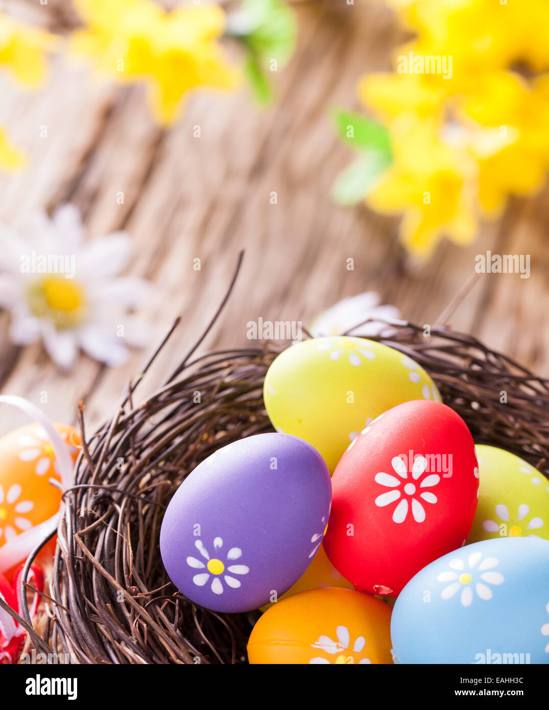 top view of traditional purple easter eggs in straw nest Stock Photo by  LightFieldStudios