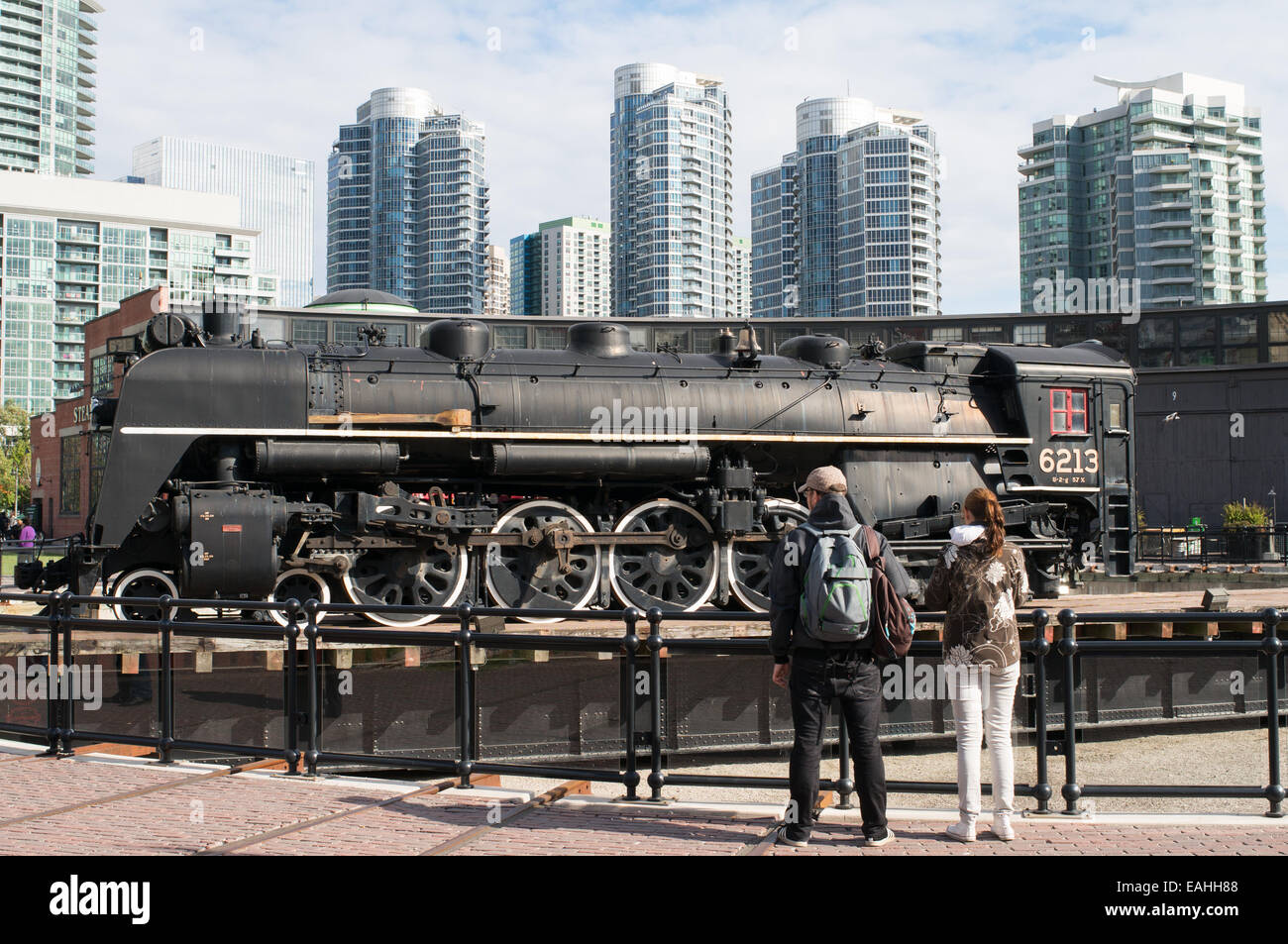 Couple looking at  steam train 6213 on turntable at John Street Roundhouse, Toronto, Ontario, Canada Stock Photo