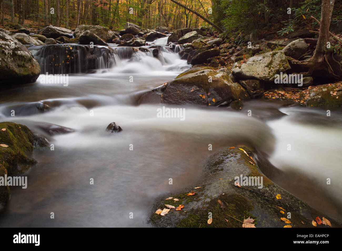 Waterfall flowing through autumn color in the Smokey Mountains near ...