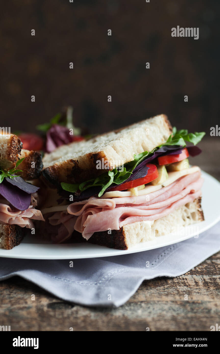 Thin sliced ham and vegetables on rustic crusty fresh country bread Stock Photo