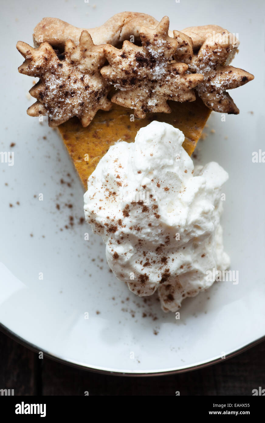 Gorgeous slice of pumpkin pie and whipped cream with cinnamon Stock Photo