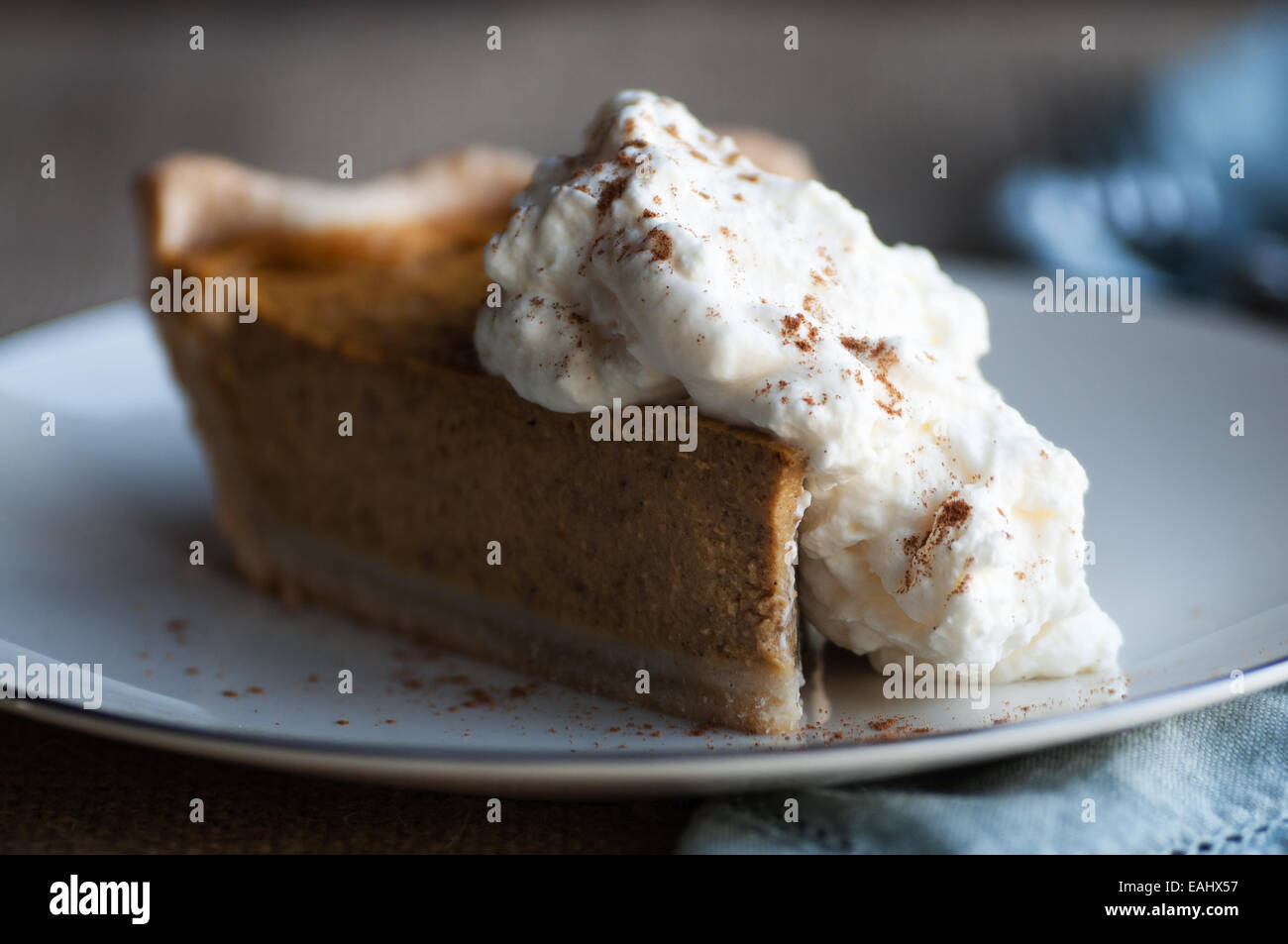 Gorgeous slice of pumpkin pie and whipped cream with cinnamon Stock Photo