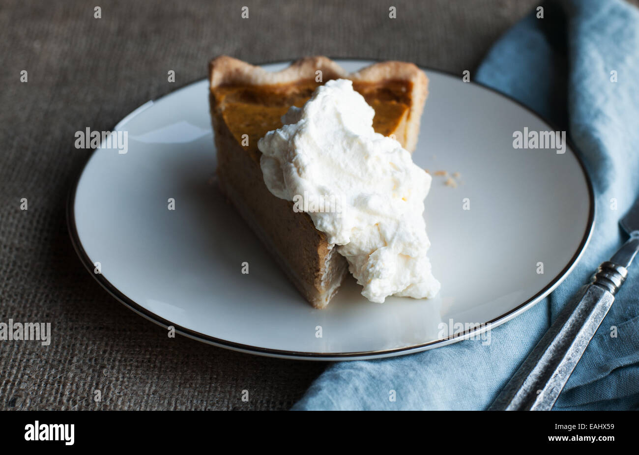 Gorgeous slice of pumpkin pie and whipped cream Stock Photo