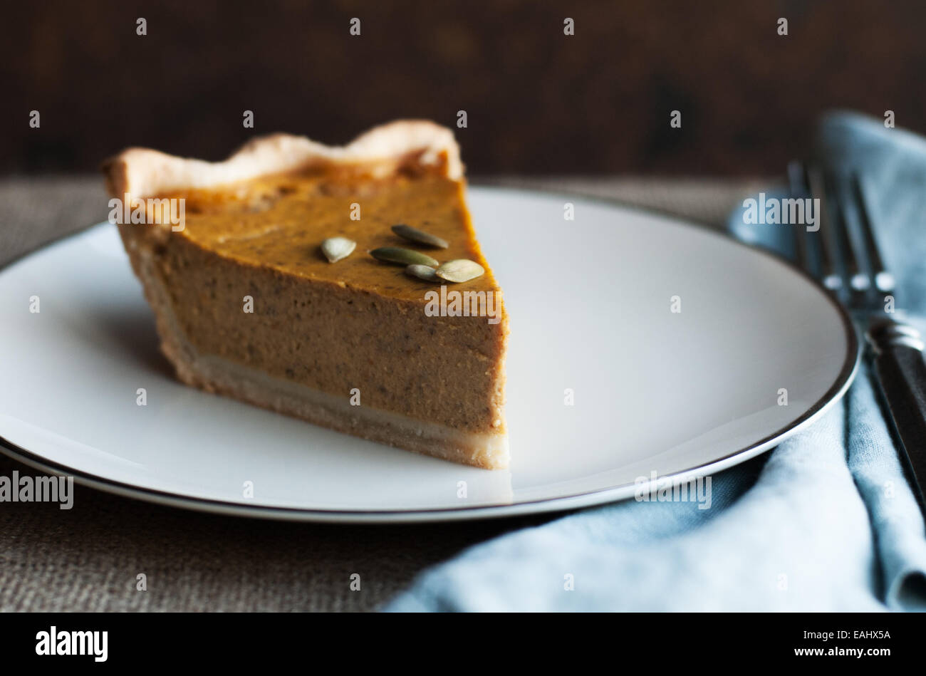 Gorgeous slice of pumpkin pie with toasted pumpkin seeds Stock Photo