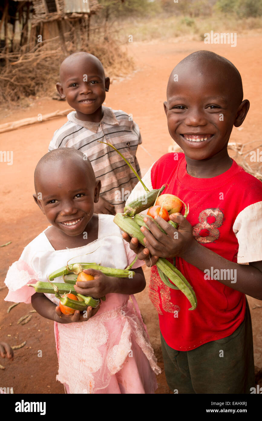 Children hold freshly harvested vegetables in Makueni County, Kenya, East Africa. Stock Photo