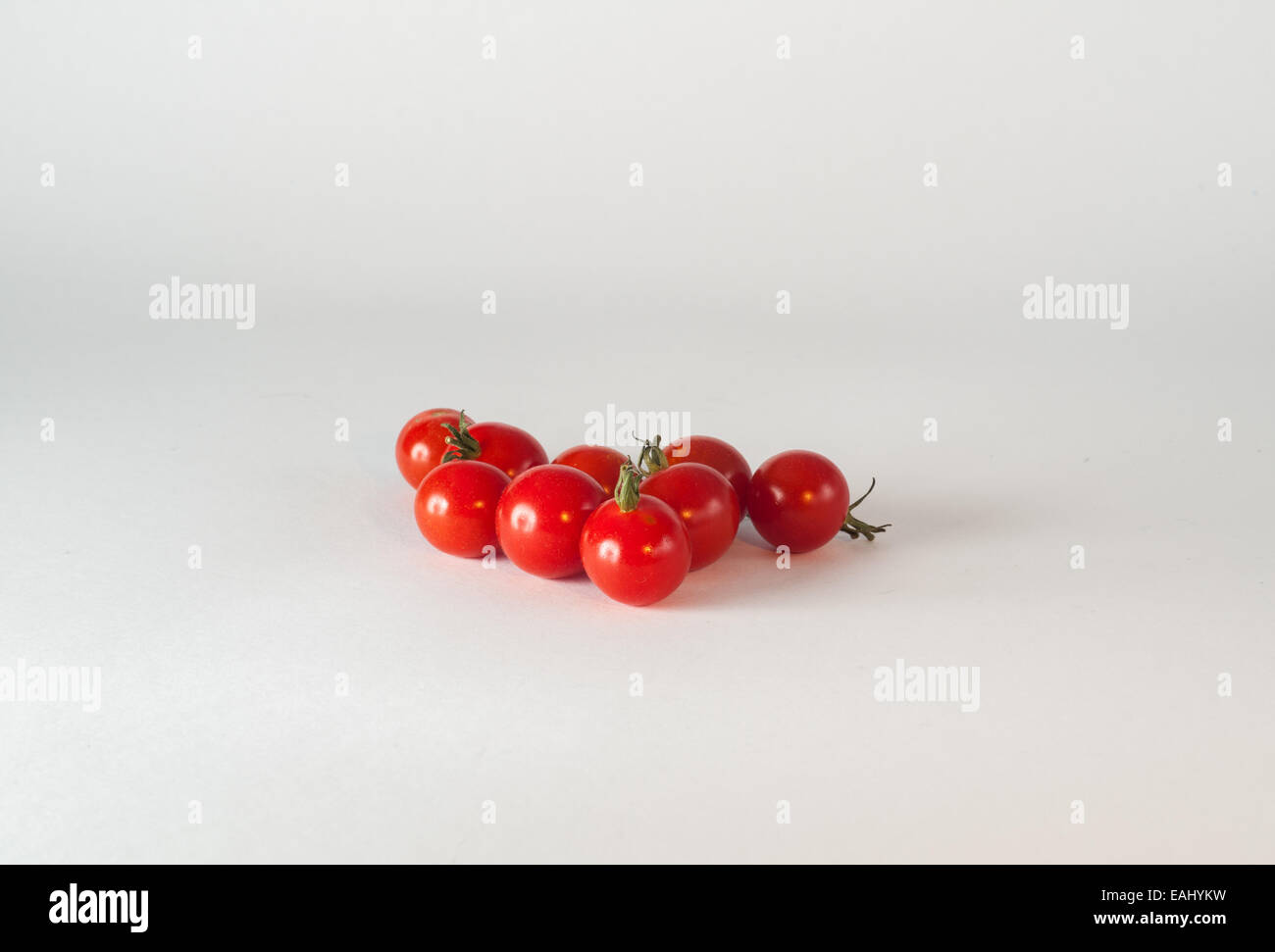 Red cherry tomato's on a white background Stock Photo - Alamy