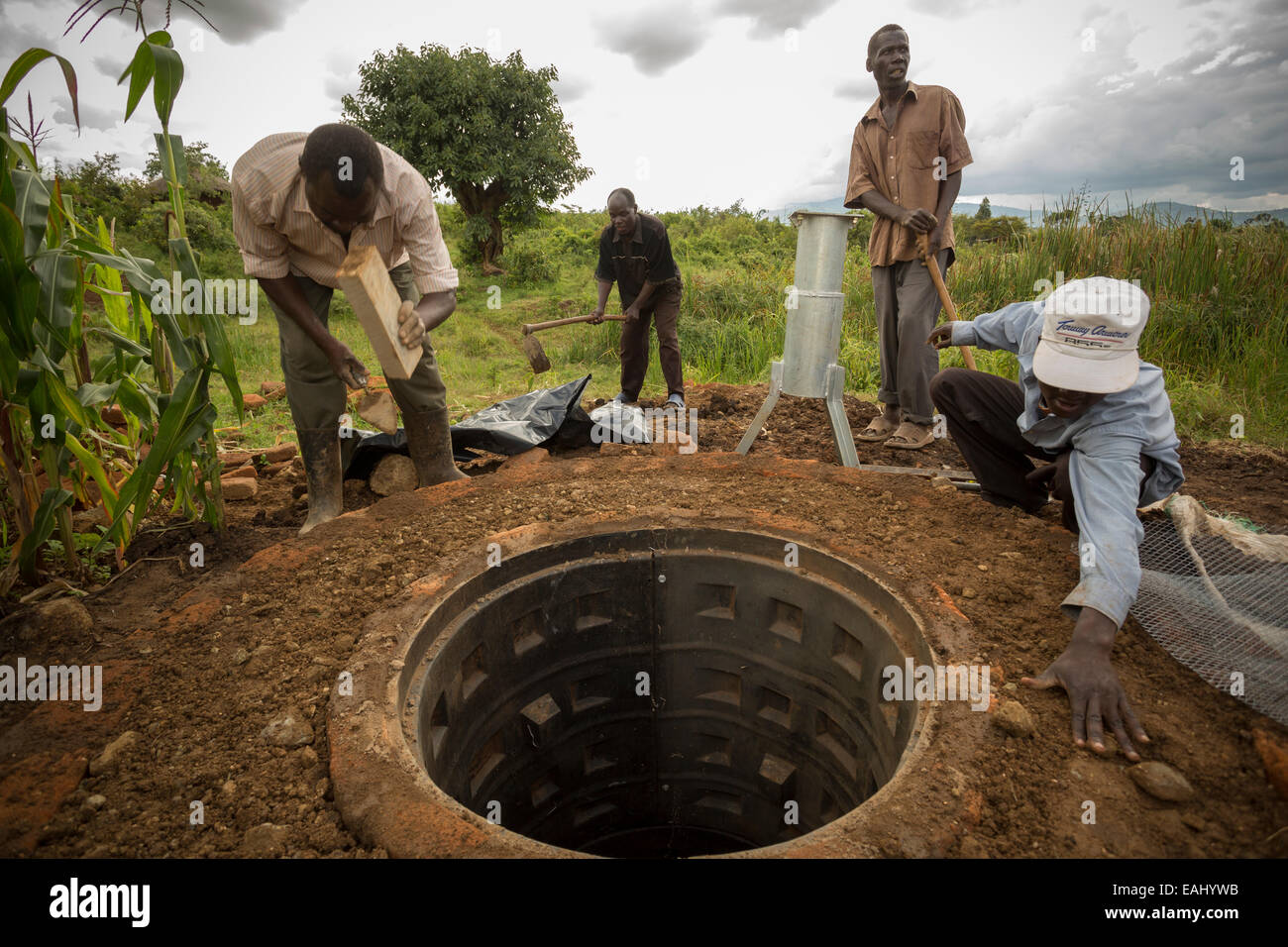Community members in Kaptali Lower village, Bukwo District, Uganda work to construct a shallow well in their community. Stock Photo